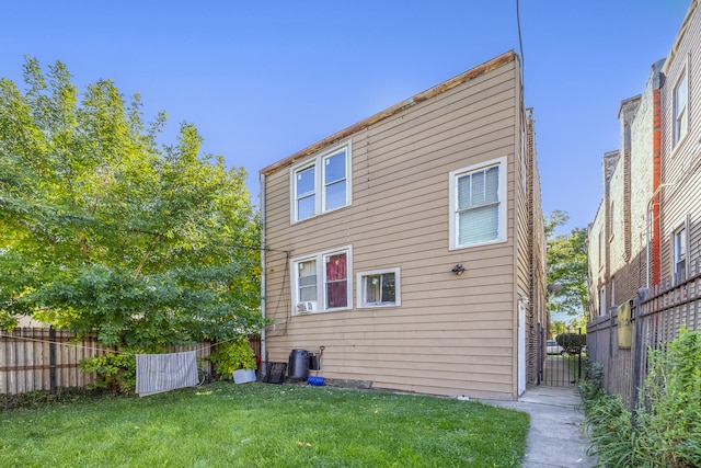 rear view of property featuring a yard