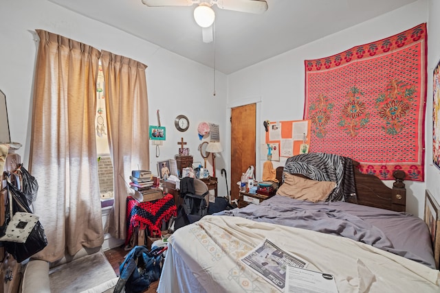 bedroom featuring hardwood / wood-style flooring, ceiling fan, and vaulted ceiling