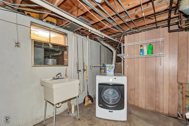 laundry area featuring water heater and sink