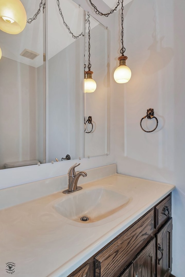 bathroom featuring vanity and toilet