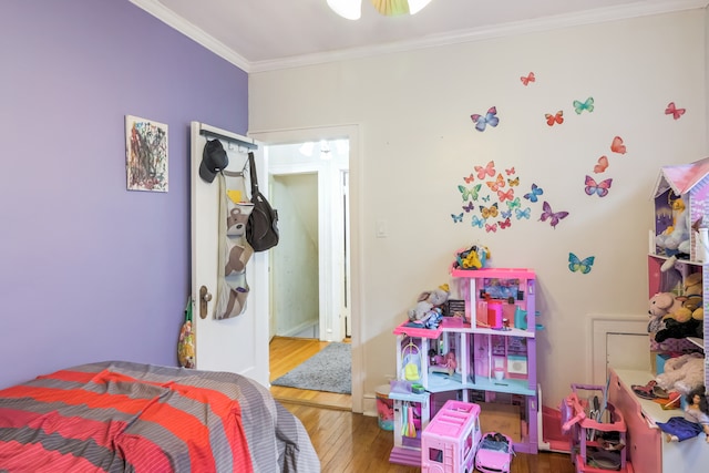 bedroom with crown molding and hardwood / wood-style floors