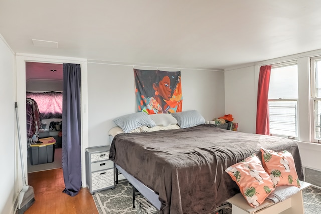 bedroom with hardwood / wood-style flooring