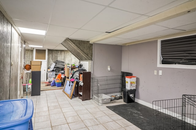 basement featuring a paneled ceiling