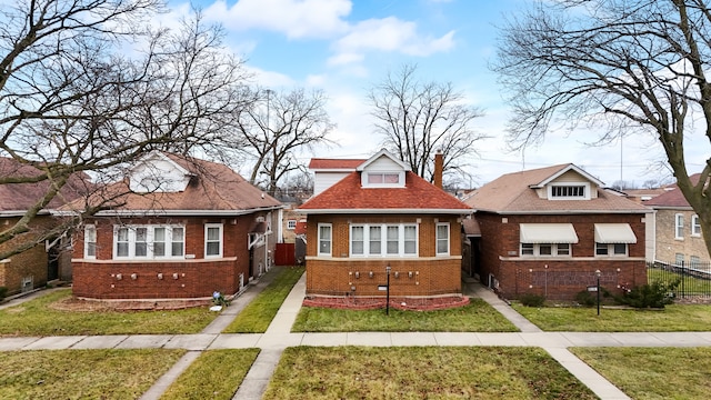 bungalow-style home featuring a front lawn