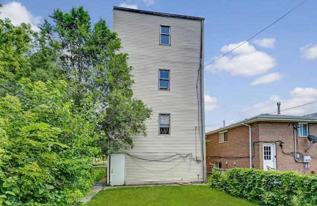 view of side of home with a lawn