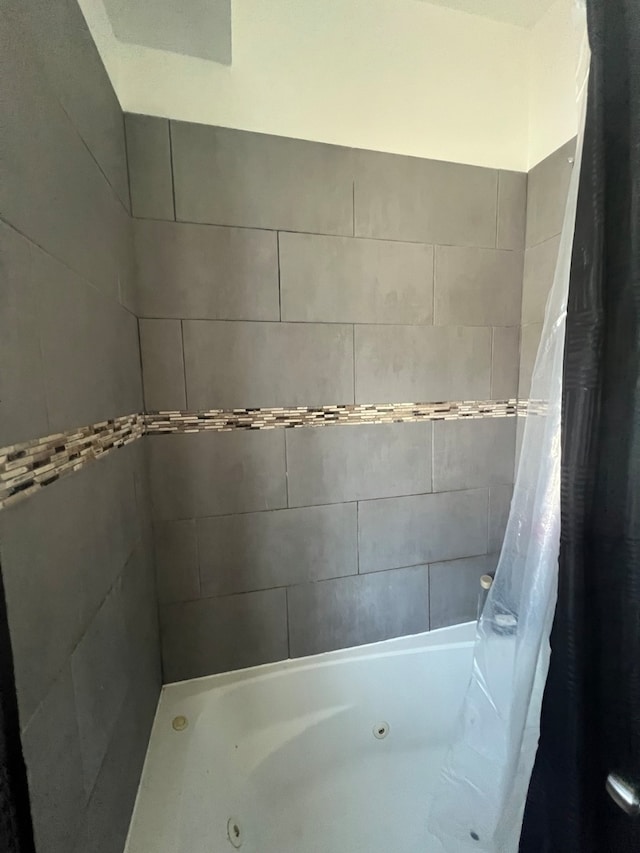 bathroom with shower / bathtub combination with curtain