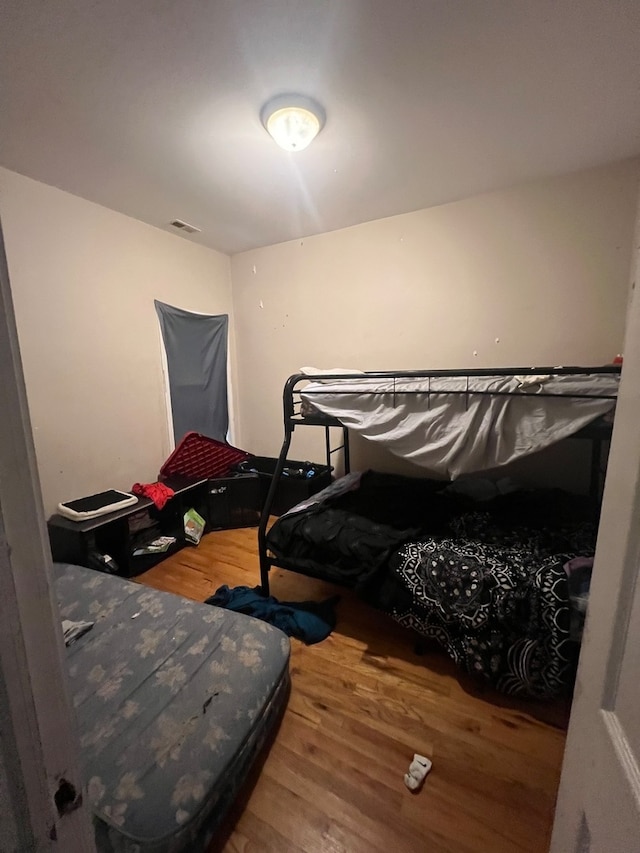 bedroom with hardwood / wood-style floors