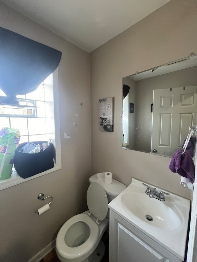 bathroom featuring vanity and toilet