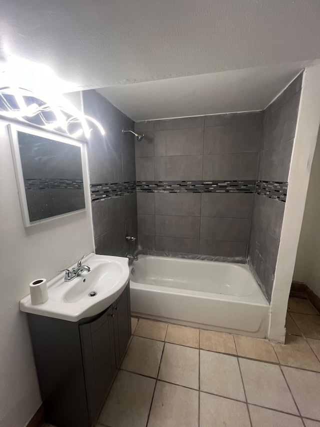 bathroom featuring vanity, tiled shower / bath combo, and tile patterned flooring