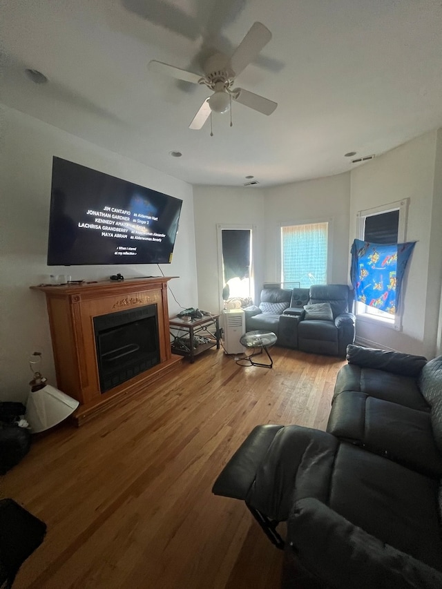 living room with ceiling fan and wood-type flooring