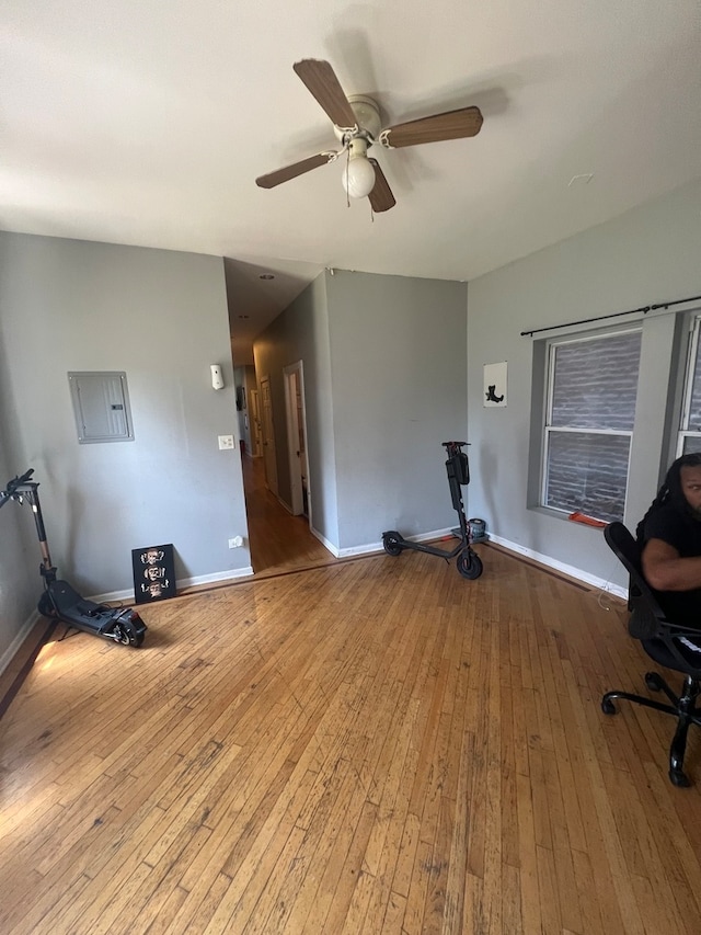 office with wood-type flooring and ceiling fan