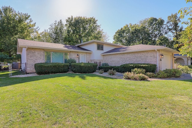 view of front of property with a front yard and a garage