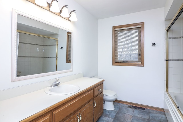 full bathroom with vanity, toilet, and enclosed tub / shower combo