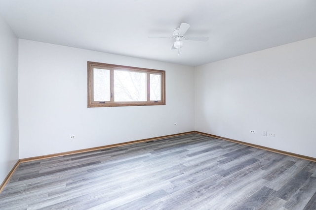 spare room with hardwood / wood-style flooring and ceiling fan