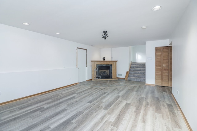 unfurnished living room with light hardwood / wood-style flooring