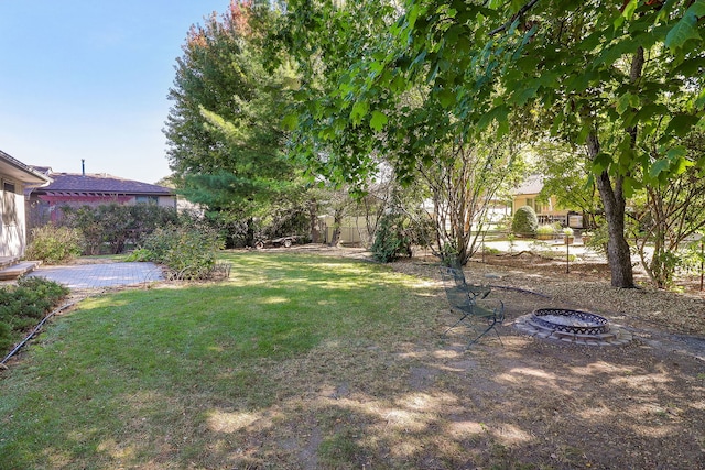 view of yard with an outdoor fire pit