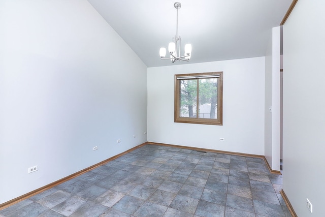 spare room featuring a chandelier