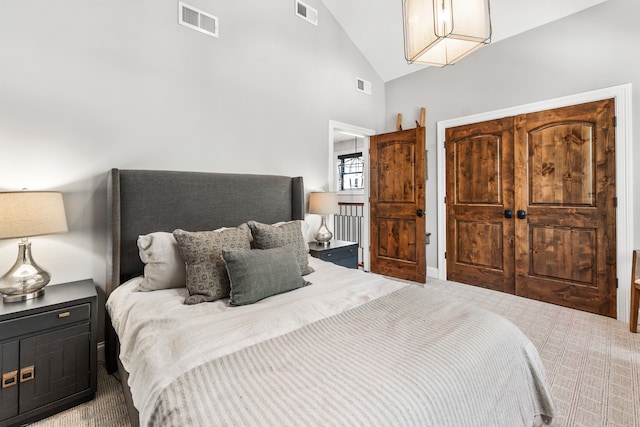 bedroom with high vaulted ceiling and carpet flooring