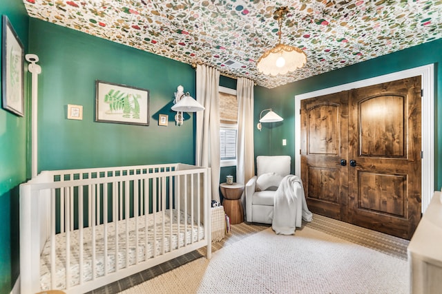 carpeted bedroom with a crib