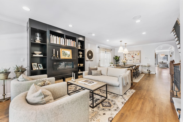 living room with crown molding and hardwood / wood-style floors