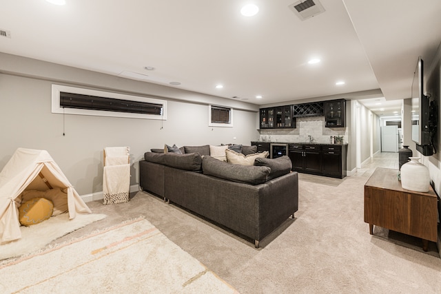 carpeted living room featuring wet bar and wine cooler