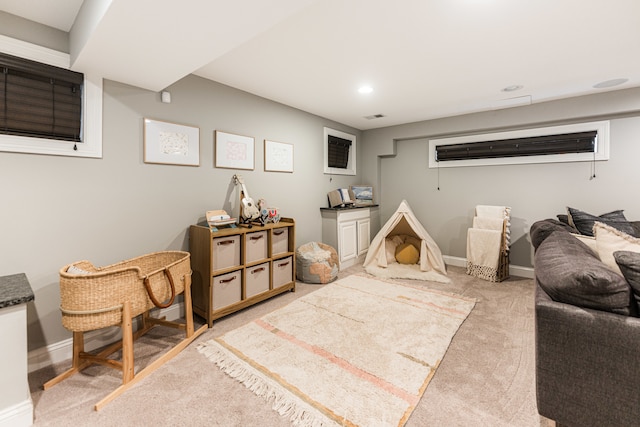 recreation room featuring light colored carpet