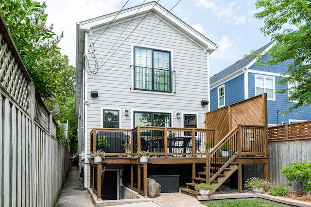 rear view of property featuring a deck