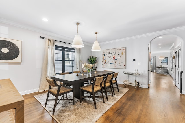 dining space with crown molding and hardwood / wood-style floors