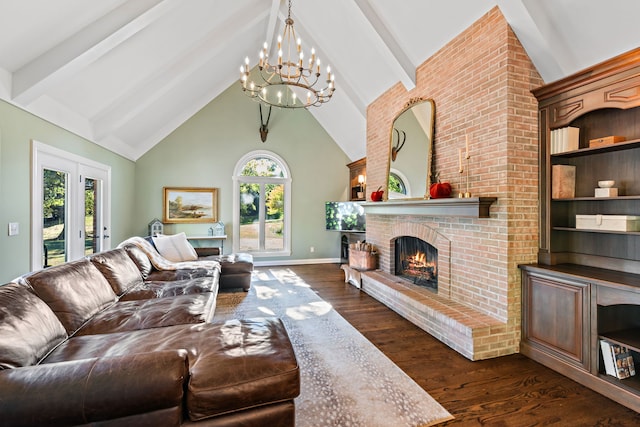 living room with a notable chandelier, beamed ceiling, a brick fireplace, and dark hardwood / wood-style floors