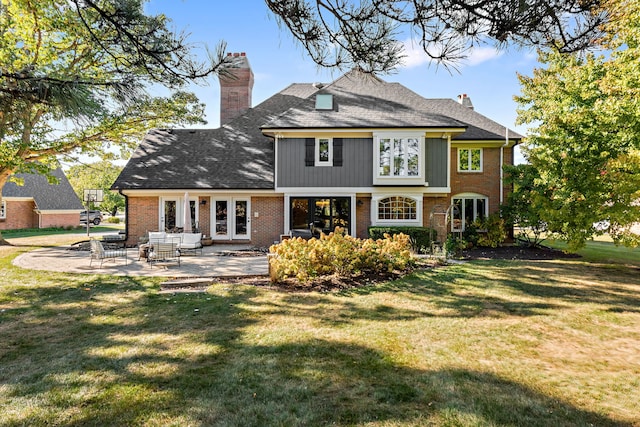 rear view of property featuring a yard and a patio area