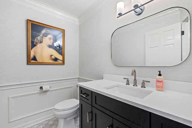 bathroom with vanity, toilet, and ornamental molding