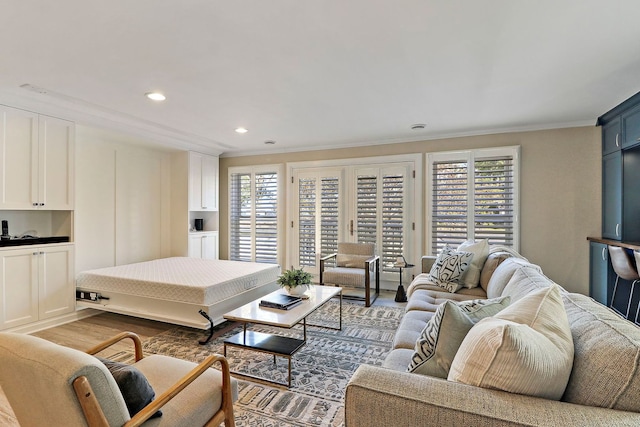 living room featuring crown molding and wood-type flooring