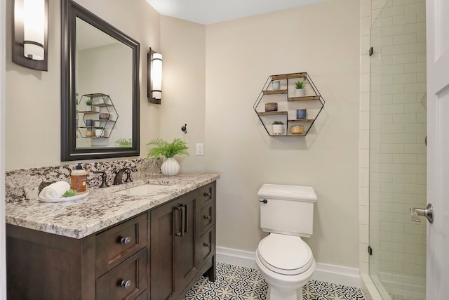 bathroom featuring toilet, walk in shower, vanity, and tile patterned flooring