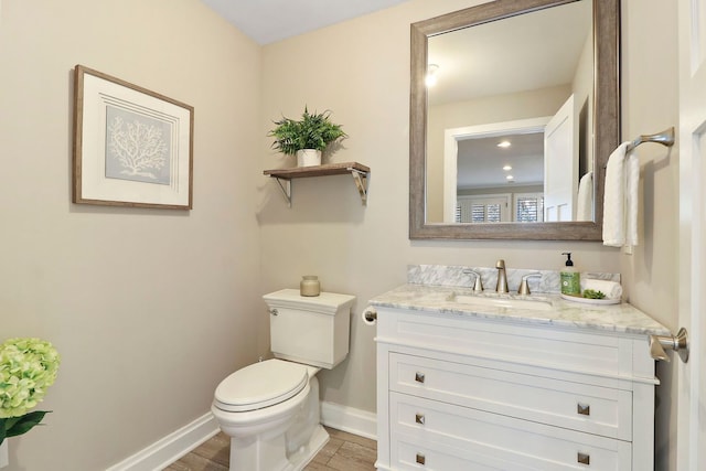 bathroom featuring vanity, toilet, and hardwood / wood-style flooring