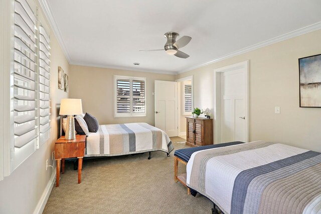 carpeted bedroom featuring ceiling fan and ornamental molding