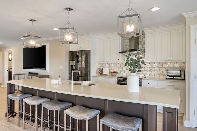 kitchen with a spacious island, pendant lighting, stainless steel appliances, and a kitchen bar