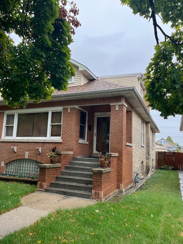 bungalow-style house featuring a front yard