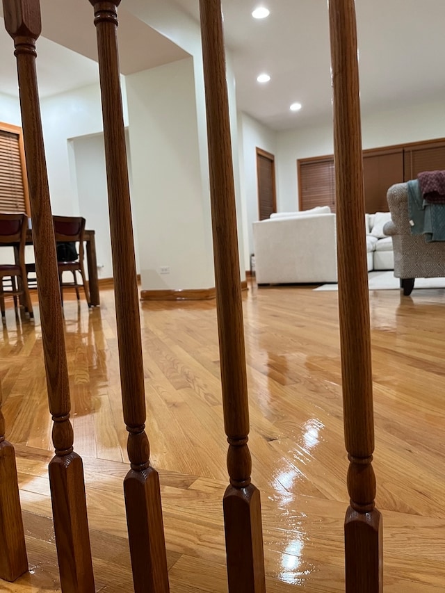 hall with wood-type flooring and ornate columns