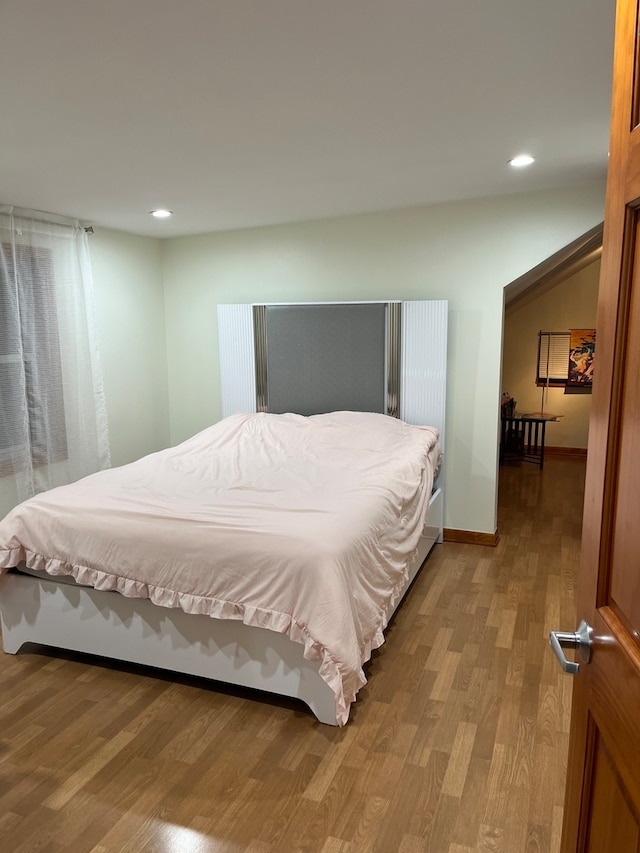 bedroom with hardwood / wood-style floors