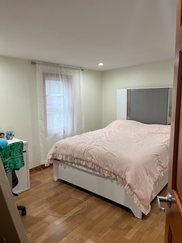 bedroom with wood-type flooring