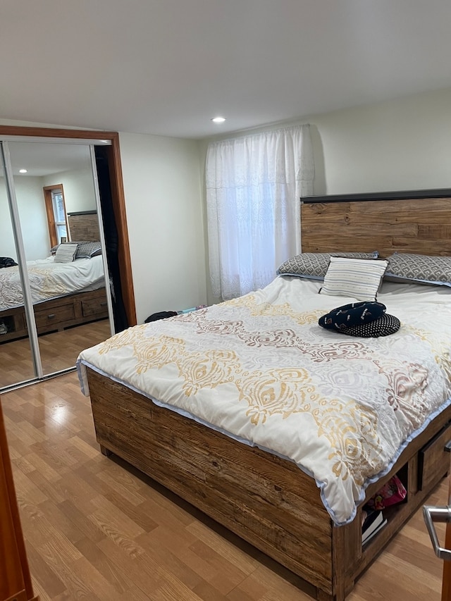 bedroom featuring a closet and light hardwood / wood-style flooring