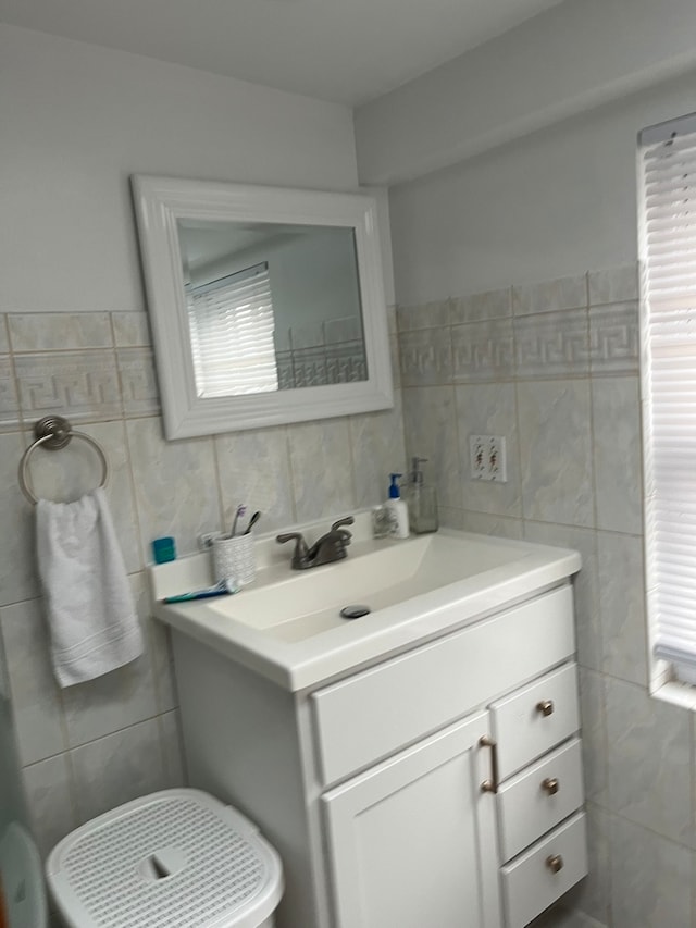 bathroom featuring tile walls and vanity