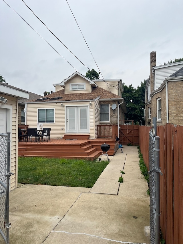 bungalow-style home featuring a front yard and a deck