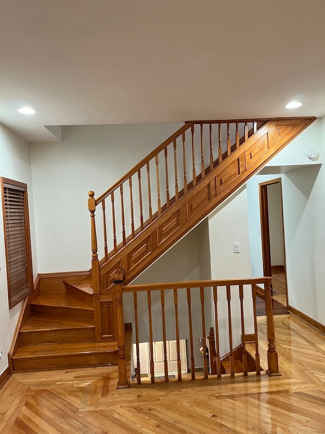 stairway featuring parquet floors