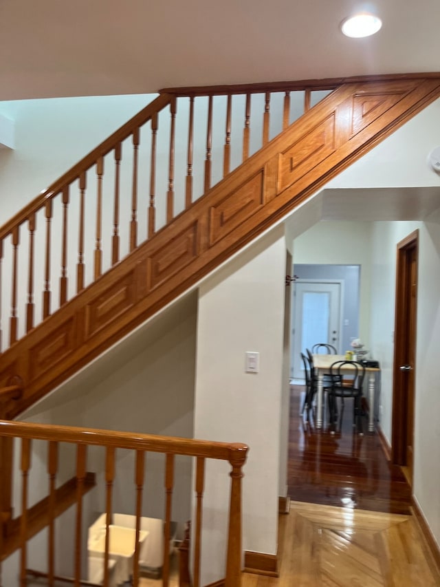 staircase featuring parquet floors