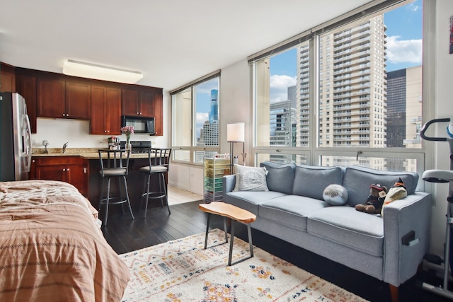 interior space featuring hardwood / wood-style flooring and stainless steel fridge