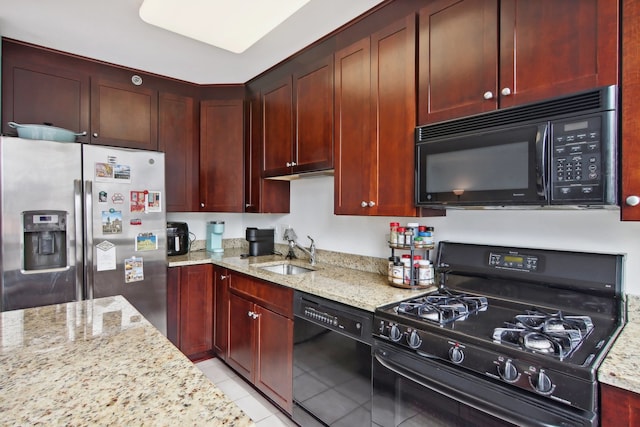 kitchen featuring light tile patterned floors, light stone countertops, sink, and black appliances