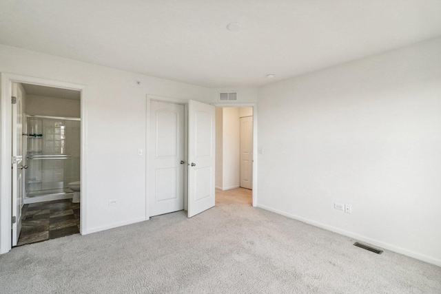 unfurnished bedroom featuring connected bathroom and light colored carpet