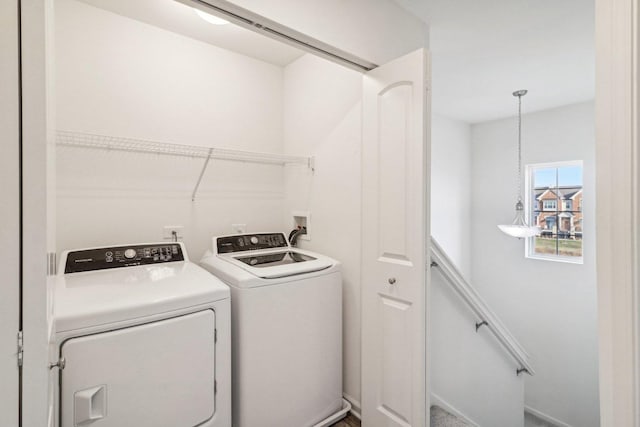 clothes washing area with separate washer and dryer