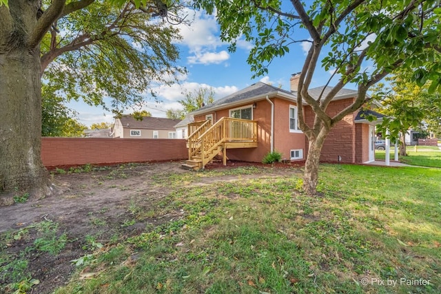 back of house with a lawn